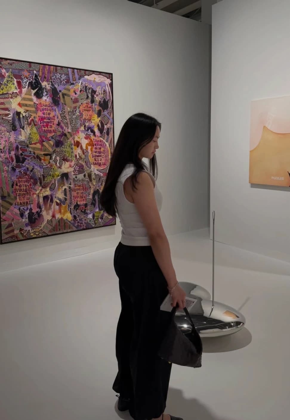 Janet Truong, founder of Atelier jT, looking at art in a gallery